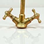 Tall copper bathroom faucet with cross handles and a polished finish, ideal for modern or classic bathrooms.