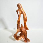 Carved Thuya wood sculpture with intricate natural grain