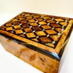 Handmade wooden jewelry box with polished Thuya grain and brass key detail