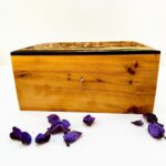 Handmade Thuya wood jewelry box with key detail and polished natural grain